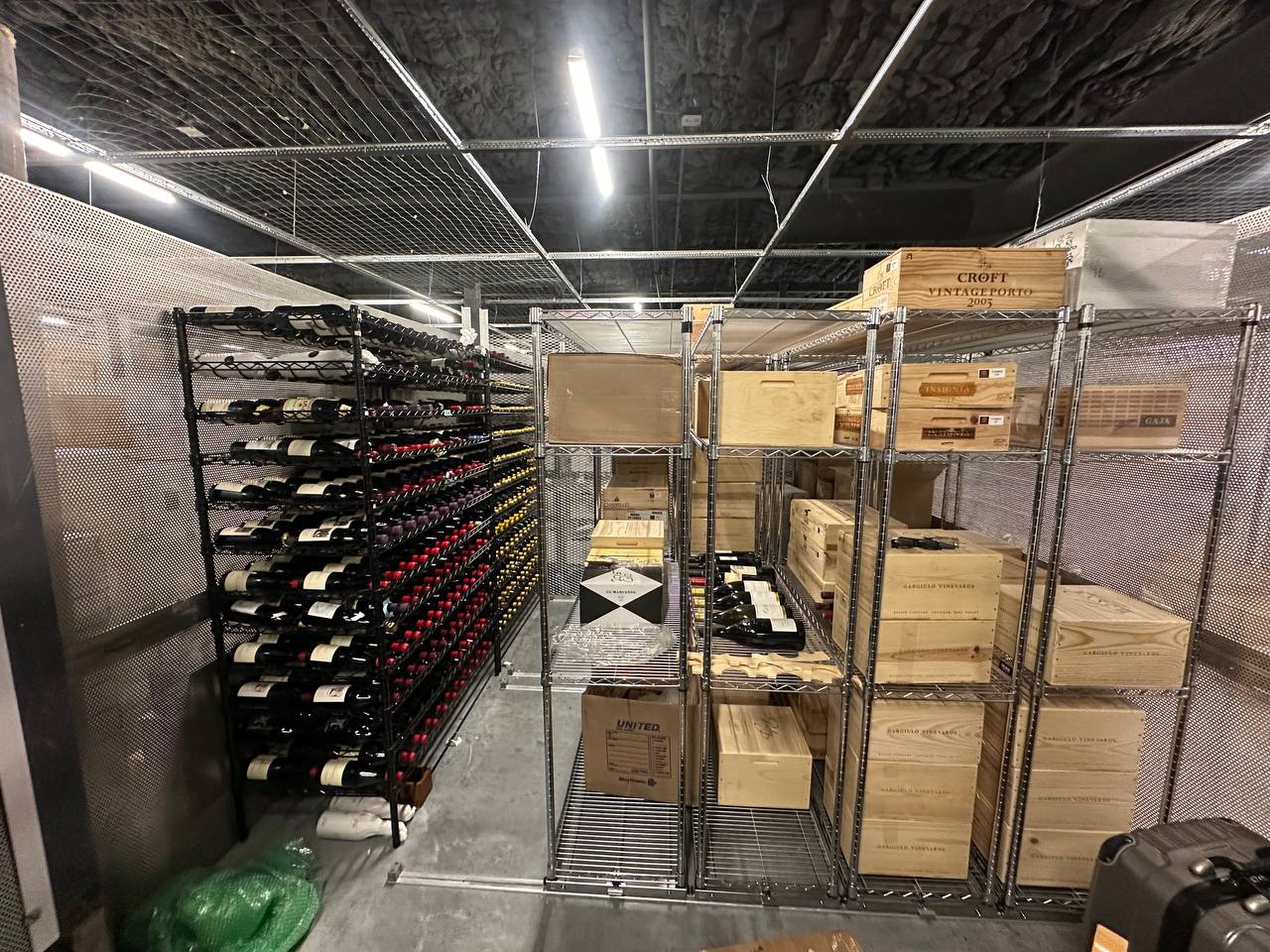 Wine storage racks with wooden crates at Carl's Wine Vault